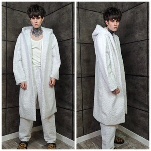 This UV Reactive Parka is the ultimate Cyber Rave statement. Designed for high-impact visibility at warehouse parties and outdoor Festivals, the Bioluminescent effect ensures you stand out in the dark. It features a deep hood for that mysterious "afterhours" look. Pro Tip: Keep the glow strong by standing near a blacklight for a few minutes to "recharge" your brightness throughout the night. Essential gear for Hardstyle, Industrial, and Trance fans.