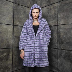 May include: A hooded coat in a lavender and gray checkered pattern. The coat has a long, relaxed fit and a hood. The coat is made of a soft, textured fabric. The coat is open in the front.