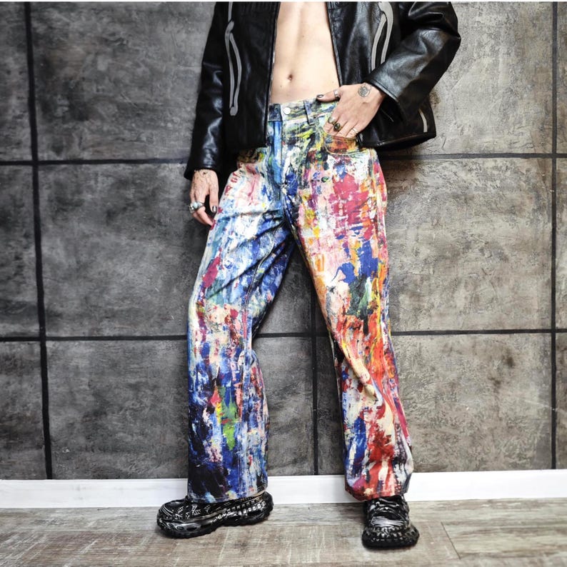 Express your bold style with these unisex paint splatter jeans, featuring vibrant colors and an edgy artistic vibe. Perfect for streetwear fans, skaters, festival goers, and creatives who love standout fashion. These jeans blend comfort with individuality, making them ideal for concerts, parties, raves, or everyday wear. A must-have for Y2K, grunge, and alternative fashion lovers seeking a unique wardrobe staple that turns heads and sets trends.