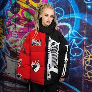 May include: A two-toned puffer jacket, red on the left and black on the right, with a skeleton print. The red side features the letters "BM", flames, and the number "3". The jacket has a high collar.