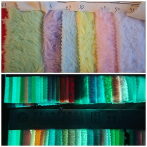 May include: A collection of colorful faux fur fabric swatches in pastel shades, including green, purple, blue, yellow, pink, and white. The bottom image shows the same fabric swatches glowing in the dark, with a variety of green and blue hues.
