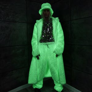 This UV Reactive Parka is the ultimate Cyber Rave statement. Designed for high-impact visibility at warehouse parties and outdoor Festivals, the Bioluminescent effect ensures you stand out in the dark. It features a deep hood for that mysterious "afterhours" look. Pro Tip: Keep the glow strong by standing near a blacklight for a few minutes to "recharge" your brightness throughout the night. Essential gear for Hardstyle, Industrial, and Trance fans.