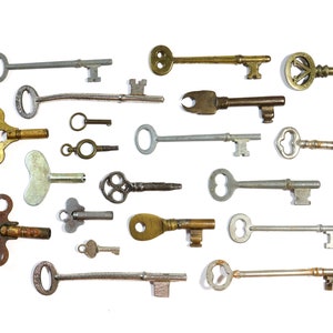 May include: A collection of antique keys in various shapes and sizes, including skeleton keys, ornate keys, and simple keys. The keys are made of brass and steel and have a worn, aged appearance.