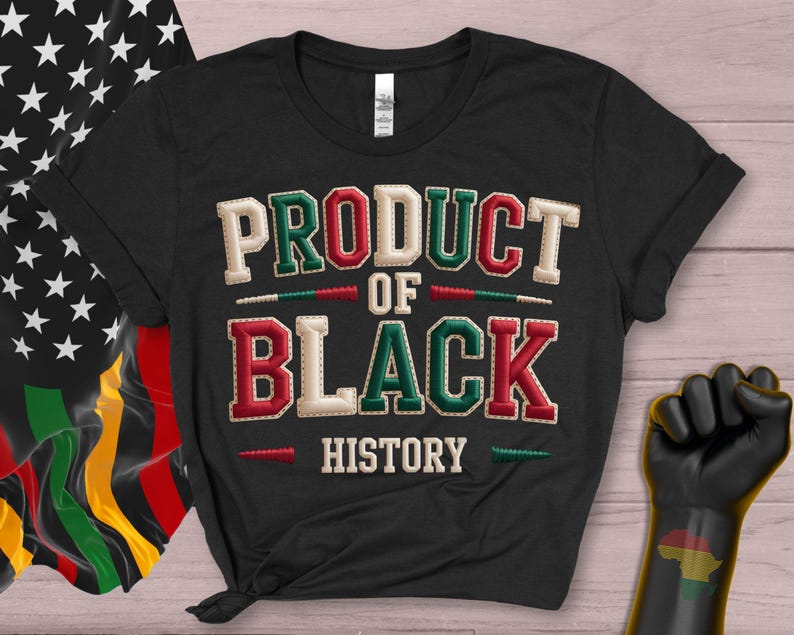 May include: Black t-shirt featuring the text "PRODUCT OF BLACK HISTORY" in green, red, and white stitched lettering. The image includes a Black Power fist and a flag with stars and the Pan-African colours.
