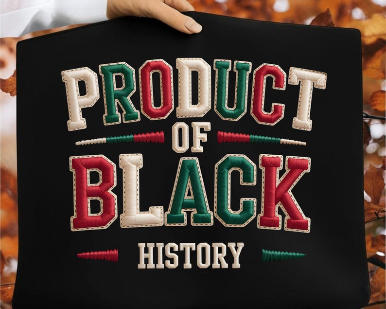 May include: Black fabric with the embroidered text "PRODUCT OF BLACK HISTORY" in white, red, and green. The letters have a stitched outline. The words are arranged in two lines with decorative elements.