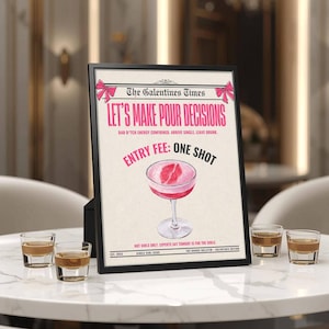 May include: A framed print with the text "Let's Make Pour Decisions" and a cocktail illustration. The print is displayed on a white marble table with several shot glasses. The text includes "Entry Fee: One Shot."