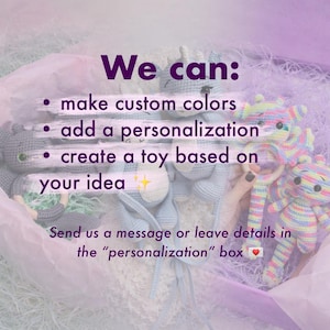 May include: Crocheted toys in a box with text that reads "We can: make custom colors, add a personalization, create a toy based on your idea." The toys are in various colors, including blue, gray, and rainbow.