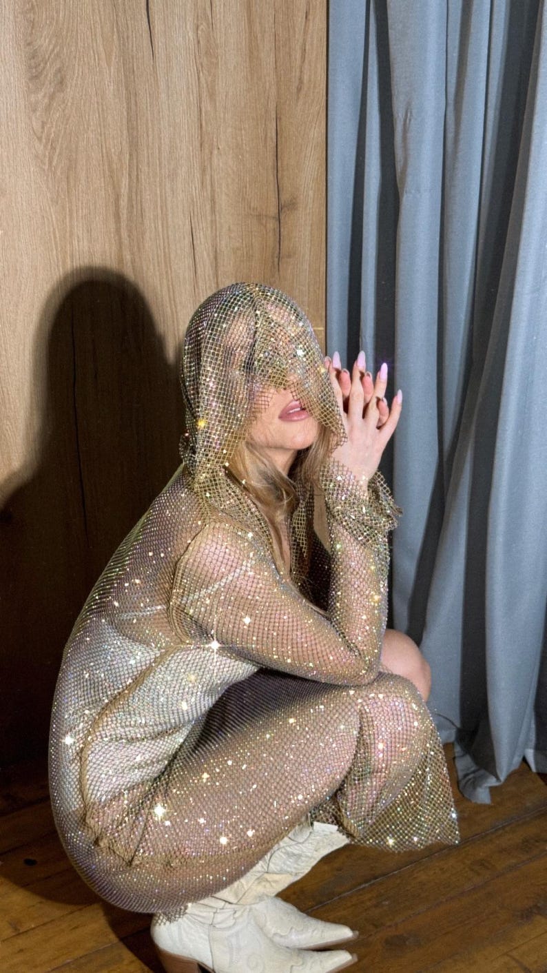 Coachella-Ready Glam 💃
Turn every festival moment into a photoshoot in this dazzling sheer rhinestone dress.