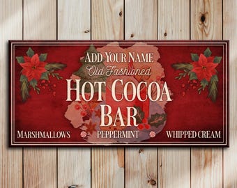May include: Red and white sign with the text "Add Your Name Old Fashioned Hot Cocoa Bar" with the words "Marshmallows", "Peppermint", and "Whipped Cream" below. The sign has a red background with a floral design.