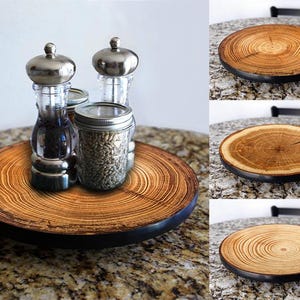 May include: A wooden serving tray with a dark rim, holding glass salt and pepper shakers with silver tops and a small jar. The tray has a natural wood grain pattern. Additional images show the wooden tray.