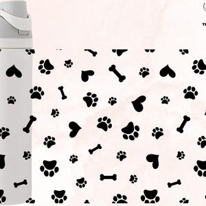 May include: White insulated water bottle with a black paw print, heart, and bone pattern. The bottle has a black lid and a black "owala" logo on the side.