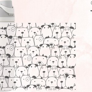 May include: White reusable water bottle with a black and white pattern of cartoon dogs on the side. The bottle has the word "owala" printed on the side.