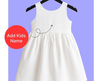 May include: A white sleeveless dress with a gathered waist, hanging on a black hanger. The dress has a simple design and is made of a light fabric. The text "Add Kids Name" is in a red circle in the image.