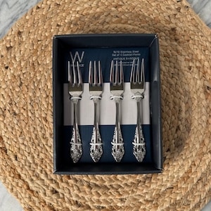 May include: A set of three ceramic mugs with a speckled, matte finish. The mugs are in shades of cream, light gray, and dark gray. Each mug has a simple, minimalist design and a rounded handle. Perfect for coffee or tea.