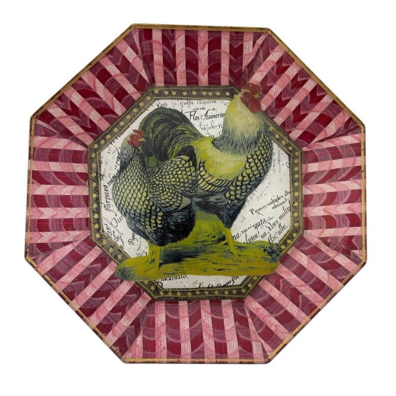 May include: An octagonal decorative plate with a rooster and hen illustration. The plate features a red and white striped border and a central image of a rooster and hen with yellow and black details. The background has script.
