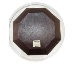 May include: A brown, octagonal dish inside a clear plastic container. The dish has a textured surface and a label with the text "ANTHROPOLOGIE". The dish is likely used for serving or display.
