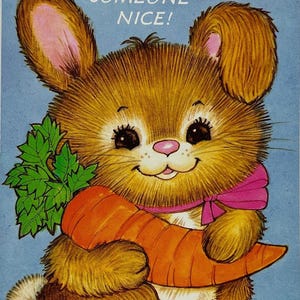 May include: A vintage illustration of a fluffy brown bunny holding a large orange carrot and green carrot top. The bunny wears a pink scarf and has the text "FOR SOMEONE NICE!" on a light blue background.