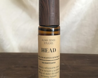May include: A brown glass roll-on bottle with a wooden cap. The label reads "ALMA SENSI STUDIO HEAD" and "10 ML / 0.34 fl. oz." The bottle contains essential oils for aromatherapy.