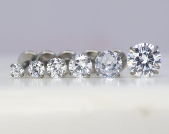 May include: A set of six clear cubic zirconia stud earrings in different sizes, all set in silver.