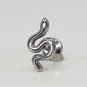 May include: Silver snake body piercing with a silver post and a flat back. The snake is curled in a figure of eight shape.