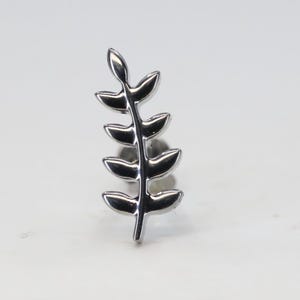 May include: Silver-toned leaf-shaped body jewellery. The jewellery is made of metal and has a delicate, intricate design.
