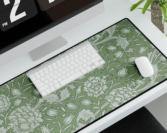 May include: A rectangular desk mat featuring a floral design in green and white. A white keyboard and mouse are positioned on the mat, with a computer monitor visible in the background. The monitor displays the time as 2:16 PM.