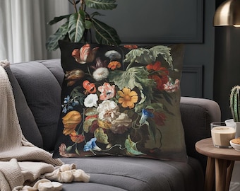 May include: A throw pillow with a dark background featuring a colorful floral arrangement. The flowers are painted in a realistic style and include red, yellow, white, and blue blooms. The pillow is perfect for adding a touch of vintage charm to any room.