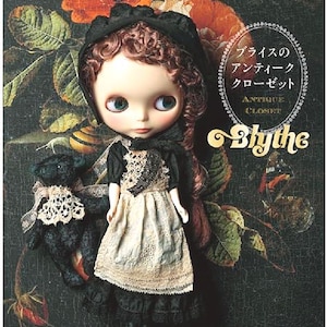 May include: A Blythe doll wearing a black dress with a white apron and a black bonnet. The doll has brown curly hair and green eyes. The doll is holding a black teddy bear with a white lace collar. The background is a floral pattern with a title that reads "Blythe Antique Closet".