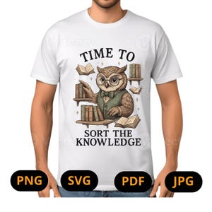 May include: White t-shirt featuring a cartoon owl wearing glasses and a vest, surrounded by books. The text "TIME TO SORT THE KNOWLEDGE" is printed above and below the owl illustration. The shirt is worn by a person.