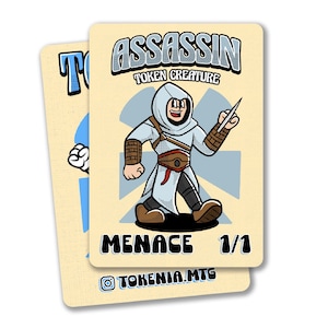 May include: Two trading cards featuring a cartoon assassin character. The main card has the word "ASSASSIN" above the character, with "TOKEN CREATURE" below. The card also has the word "MENACE" and "1/1". The second card has the letter "T" and a cartoon hand.