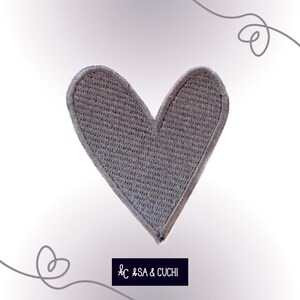 May include: A gray felt heart-shaped patch. The patch is about 3 inches wide and 3 inches tall.