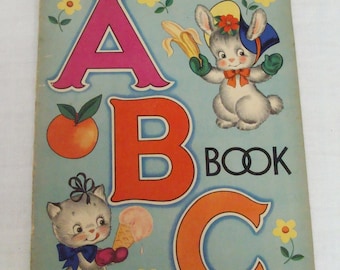 May include: Vintage ABC book with a light blue cover. The cover features the letters A, B, and C in bright colors, along with illustrations of a bunny, a kitten, an orange, a banana, and an ice cream cone. The word "BOOK" is in black.