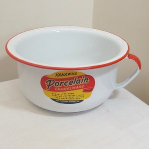 May include: White enamelware chamber pot with a red rim and handle. The pot features a colorful label that reads "KANAWHA Porcelain Enamelware". The label also states "Durable Titanium Finish".
