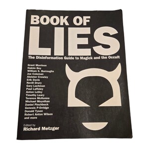 May include: A black book with the title "Book of Lies: The Disinformation Guide to Magick and the Occult" and a white devil's head graphic. The book lists authors including Grant Morrison, Hakim Bey, William S. Burroughs, and more.