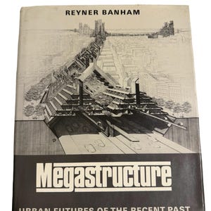 May include: A vintage book titled "Megastructure" by Reyner Banham. The cover features a black and white architectural illustration of a futuristic cityscape. The book's title is in bold white letters on a black background.