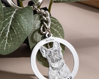 May include: A circular silver-toned metal keyring featuring a laser-engraved portrait of a French Bulldog. The top of the ring is inscribed with the name Archie, and the bottom features the text Forever Loved with a heart and paw print icon.