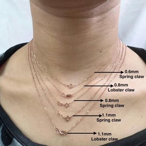May include: Five gold chains of different lengths and thicknesses with different clasps. The chains are labeled with their thickness and clasp type: 0.6mm spring claw, 0.8mm lobster claw, 0.8mm spring claw, 1.1mm spring claw, and 1.1mm lobster claw.