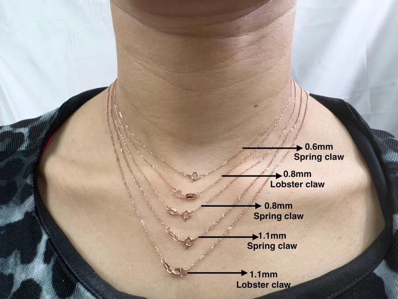 May include: Five gold chains of different lengths and thicknesses with different clasps. The chains are labeled with their thickness and clasp type: 0.6mm spring claw, 0.8mm lobster claw, 0.8mm spring claw, 1.1mm spring claw, and 1.1mm lobster claw.