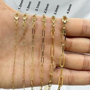 May include: A close-up of seven gold chains of different widths, ranging from 1.2mm to 4.0mm. The chains are laid out on a hand, with the widths labeled above each chain.