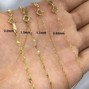 May include: Four gold-colored necklaces with varying chain thicknesses are displayed. The chains are 2.2mm, 1.5mm, 1.1mm, and 0.80mm thick, each with a lobster clasp. The necklaces have a twisted rope design, reflecting light.