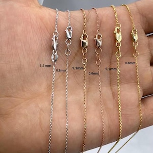 May include: Six different chain necklaces in various metals, including silver, gold, and rose gold. The chains are displayed on a hand, and each chain has a clasp. The chains are labeled with their thickness in millimeters: 1.1 mm, 0.8 mm, 1.1 mm, 0.8 mm, 1.1 mm, and 0.8 mm.