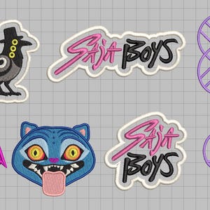 May include: A collection of eight embroidered patches featuring a black bird in a top hat, two patches with the text Saja Boys in pink and black, a pink shield with a white animal face, a blue cat face with yellow eyes, and two purple geometric designs.