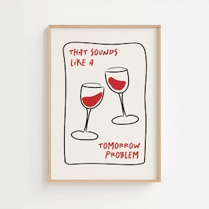 May include: A framed art print featuring two wine glasses filled with red liquid. The text "THAT SOUNDS LIKE A TOMORROW PROBLEM" is written in red within a black outlined shape.