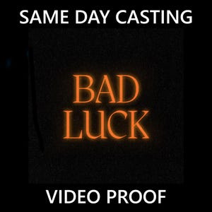 May include: A black graphic with the words "BAD LUCK" in orange, glowing letters. The text is centered on the image. Above the text is the phrase "SAME DAY CASTING" and below is "VIDEO PROOF", both in white.