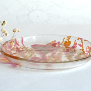 Plato de vidrio transparente pintado a mano con patrón botánico.