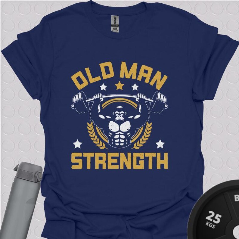 May include: Navy blue t-shirt with a graphic of a gorilla lifting weights. The text "Old Man Strength" is printed in yellow on the shirt.