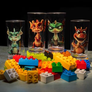 May include: Four clear glass cups with colorful cartoon dragons printed on them. The cups are surrounded by colorful plastic building blocks.
