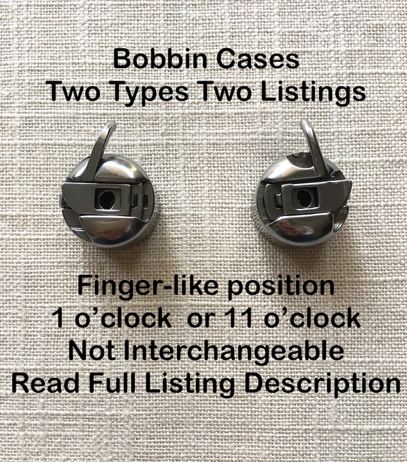 May include: Two silver bobbin cases for a sewing machine. The cases are designed to be placed in a finger-like position at either 1 o'clock or 11 o'clock. The text "Bobbin Cases Two Types Two Listings" is at the top of the image. The text "Finger-like position 1 o'clock or 11 o'clock Not Interchangeable Read Full Listing Description" is at the bottom of the image.