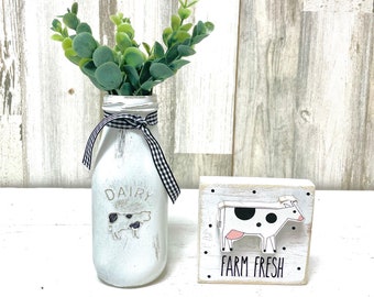 Farmhouse kitchen tiered tray decor, Distressed glass milk bottle vase and wooden cow sign