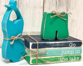 Wooden bathing suits and Go jump in the lake book stack for cottage decor, Lake house tiered tray, Rustic fish shelf sitter